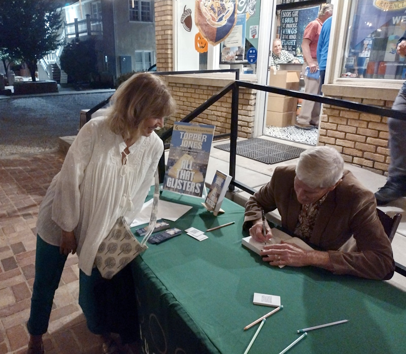 Topper Jones autographing a novel for a Book Launch guest.